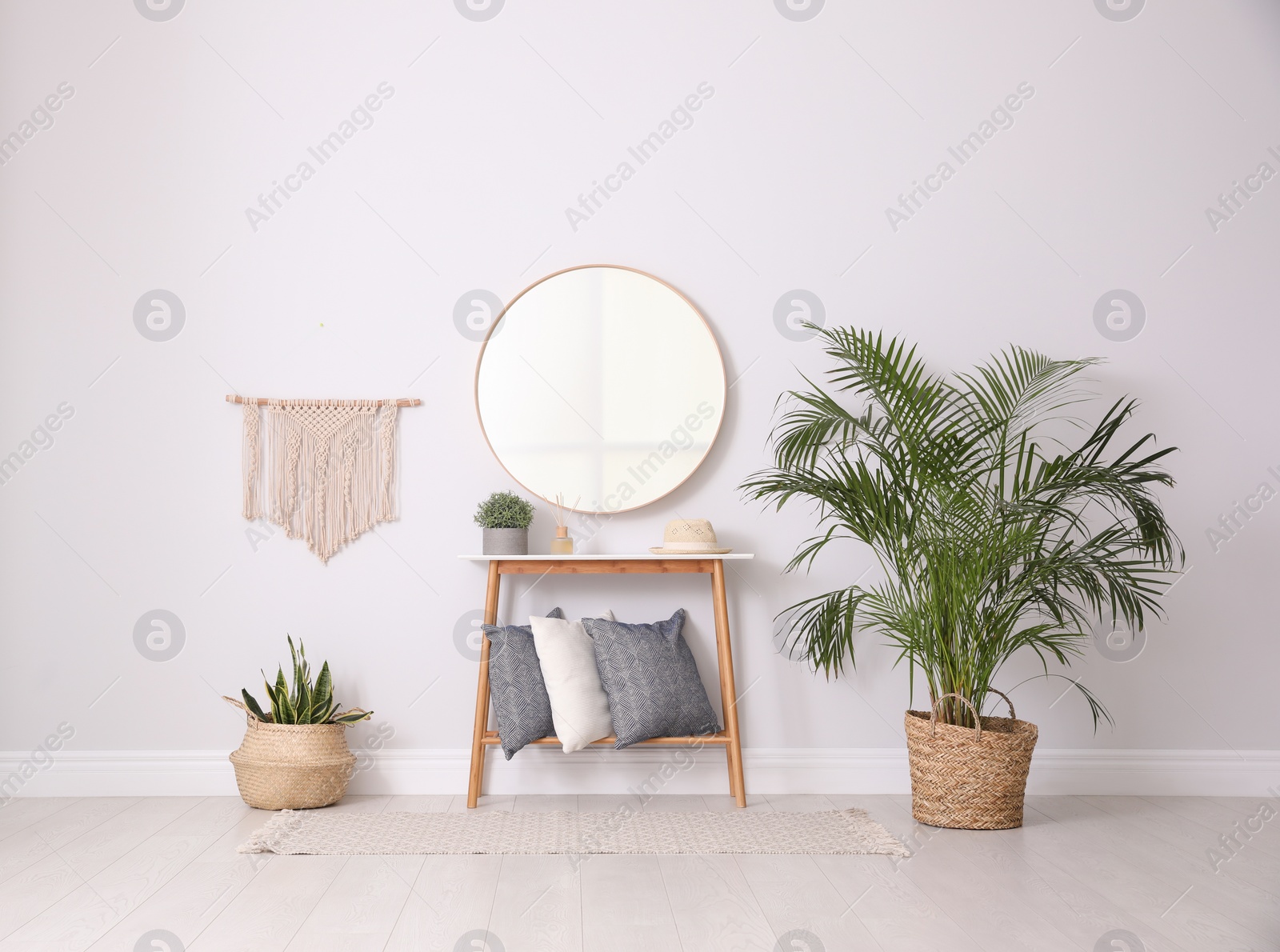 Photo of Round mirror and plants at home. Idea for interior design