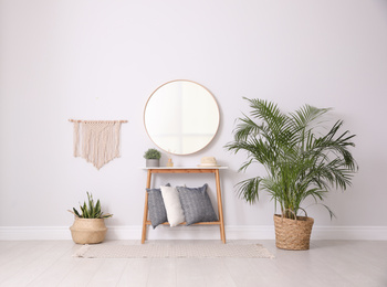 Round mirror and plants at home. Idea for interior design