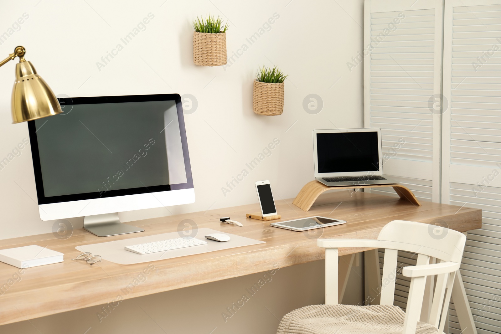 Photo of Stylish workplace interior with modern computer on table. Mockup for design