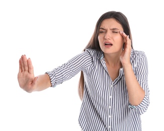 Young woman with vision problem on white background