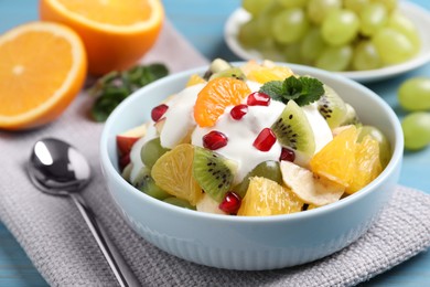 Photo of Delicious fruit salad with yogurt on table