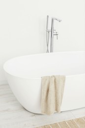 Beautiful white tub with towel in bathroom. Interior design