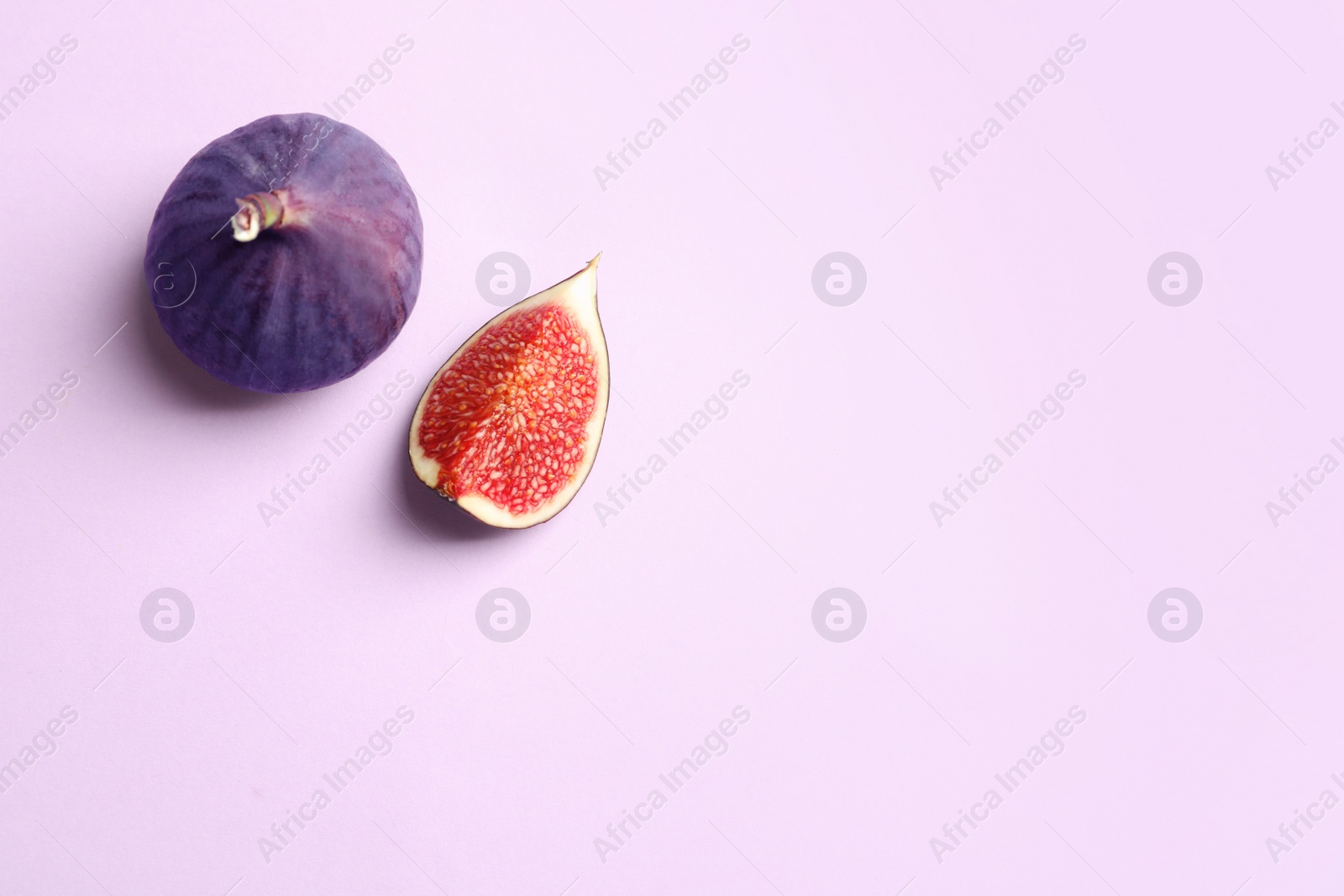 Photo of Fresh ripe figs on light background, top view. Space for text