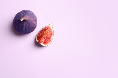 Fresh ripe figs on light background, top view. Space for text