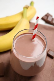 Fresh yummy chocolate milk in glass on table, closeup