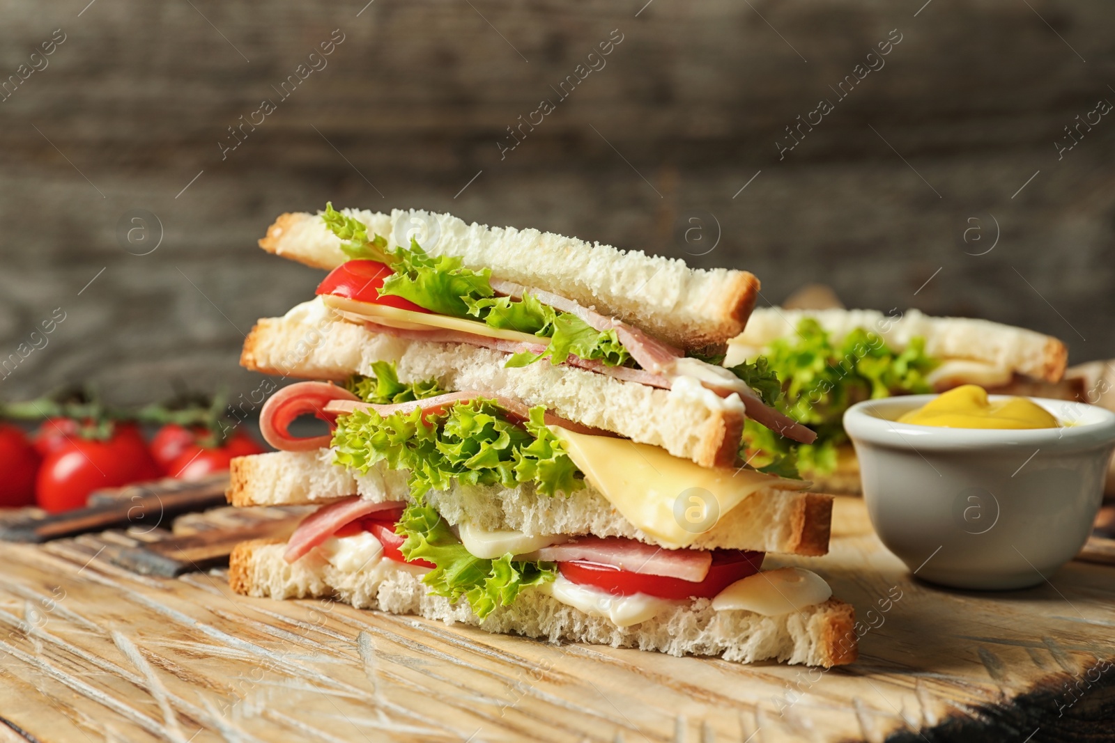 Photo of Tasty toast sandwich on wooden board. Wheat bread