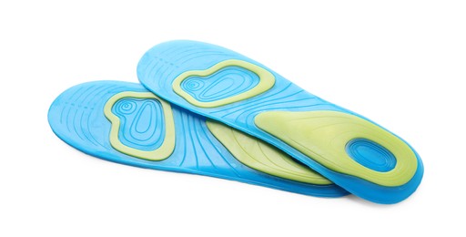 Photo of Light blue orthopedic insoles isolated on white