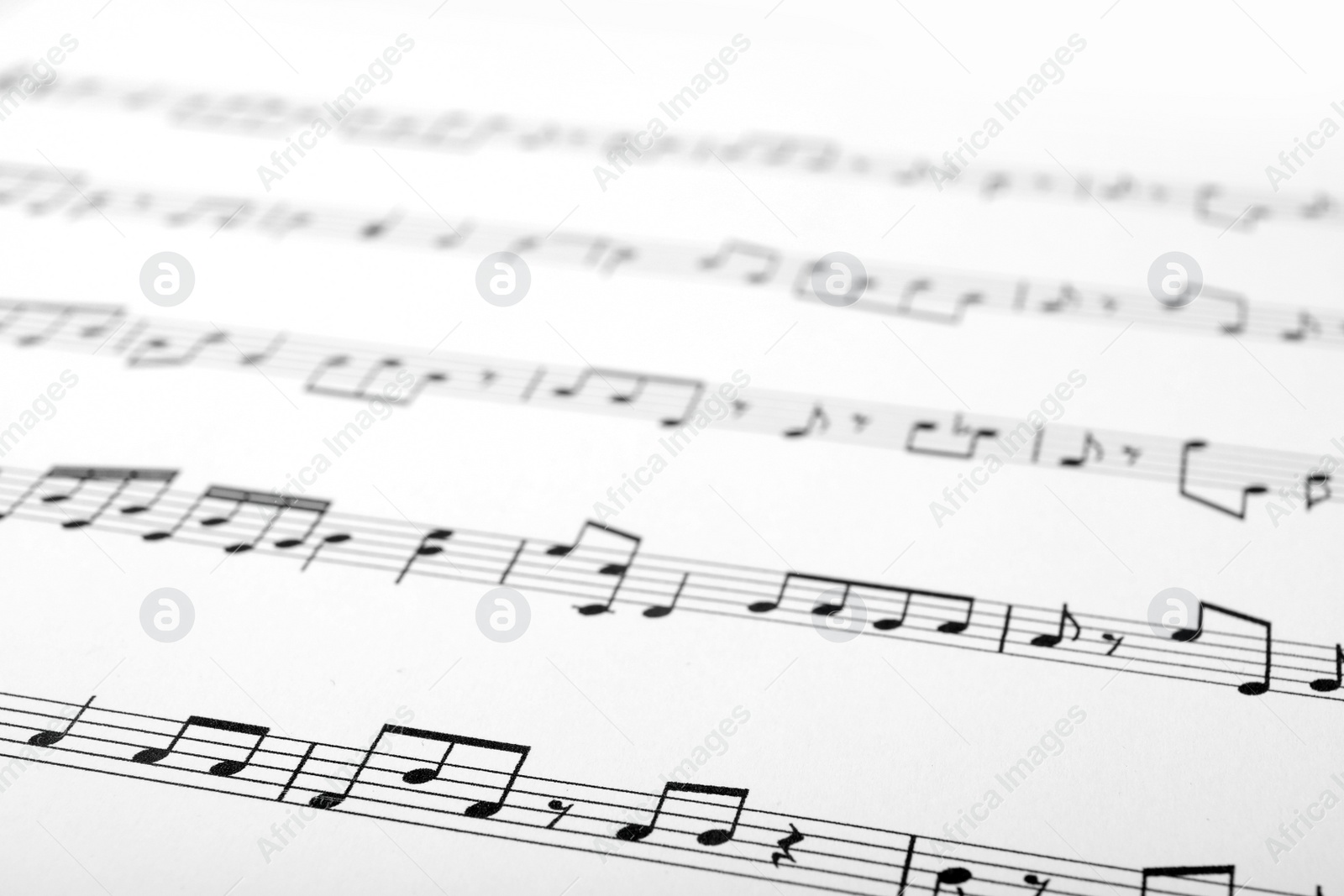 Photo of Sheet with music notes as background, closeup