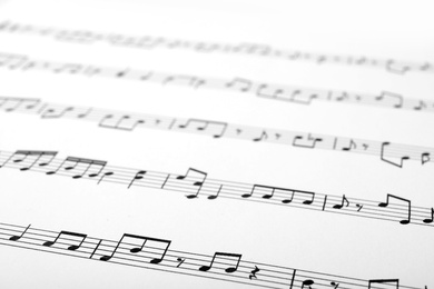 Photo of Sheet with music notes as background, closeup