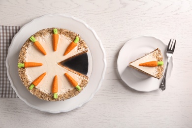 Flat lay composition with sweet carrot cake on white wooden table