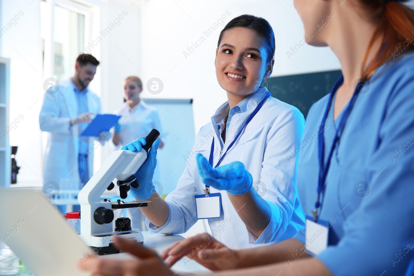 Photo of Group of scientists working in modern chemistry laboratory