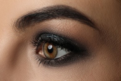 Photo of Young woman with evening makeup, closeup. Eye shadow product