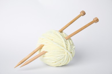Photo of Soft yarn and knitting needles on white background