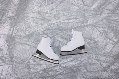 Photo of Pair of figure skates on ice, flat lay