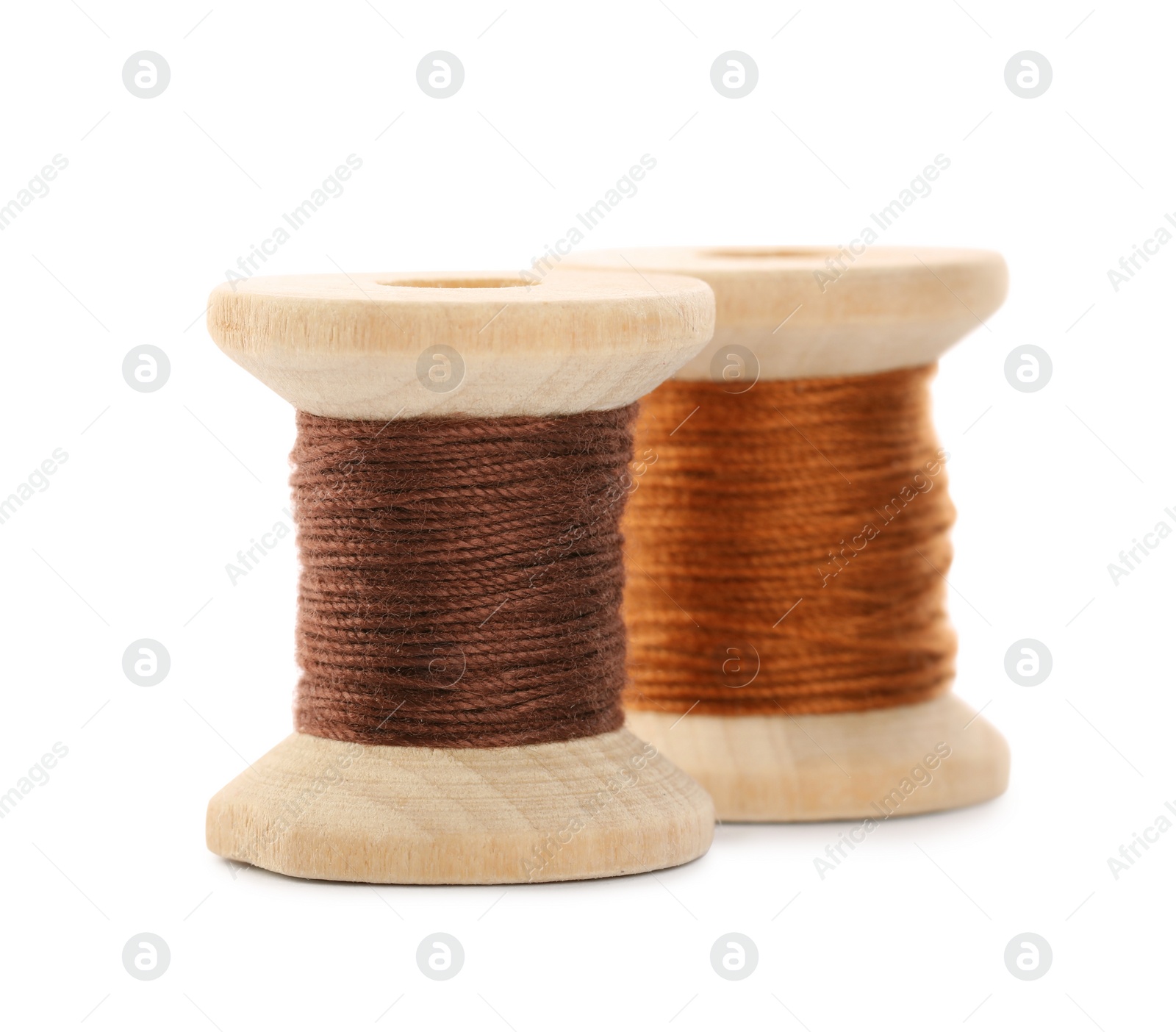 Photo of Different colorful sewing threads on white background