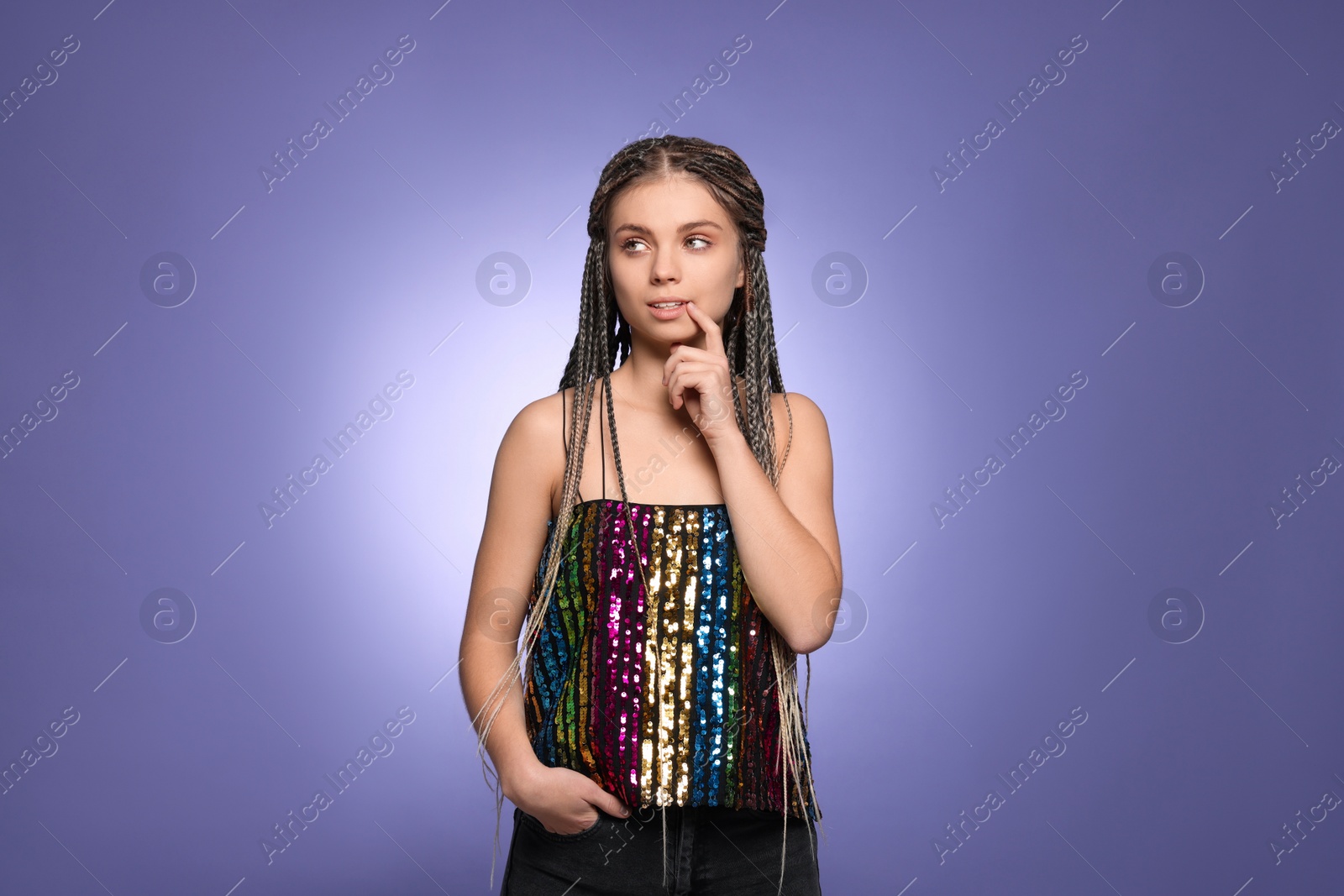 Photo of Beautiful woman with long african braids on purple background