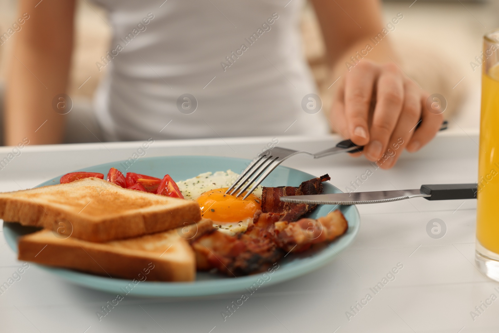 Photo of Woman having breakfast on bed at home, closeup