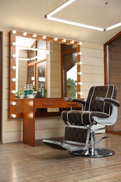 Photo of Hairdressing salon interior with large mirror and chair