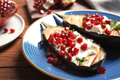 Plate with fried eggplants on wooden table