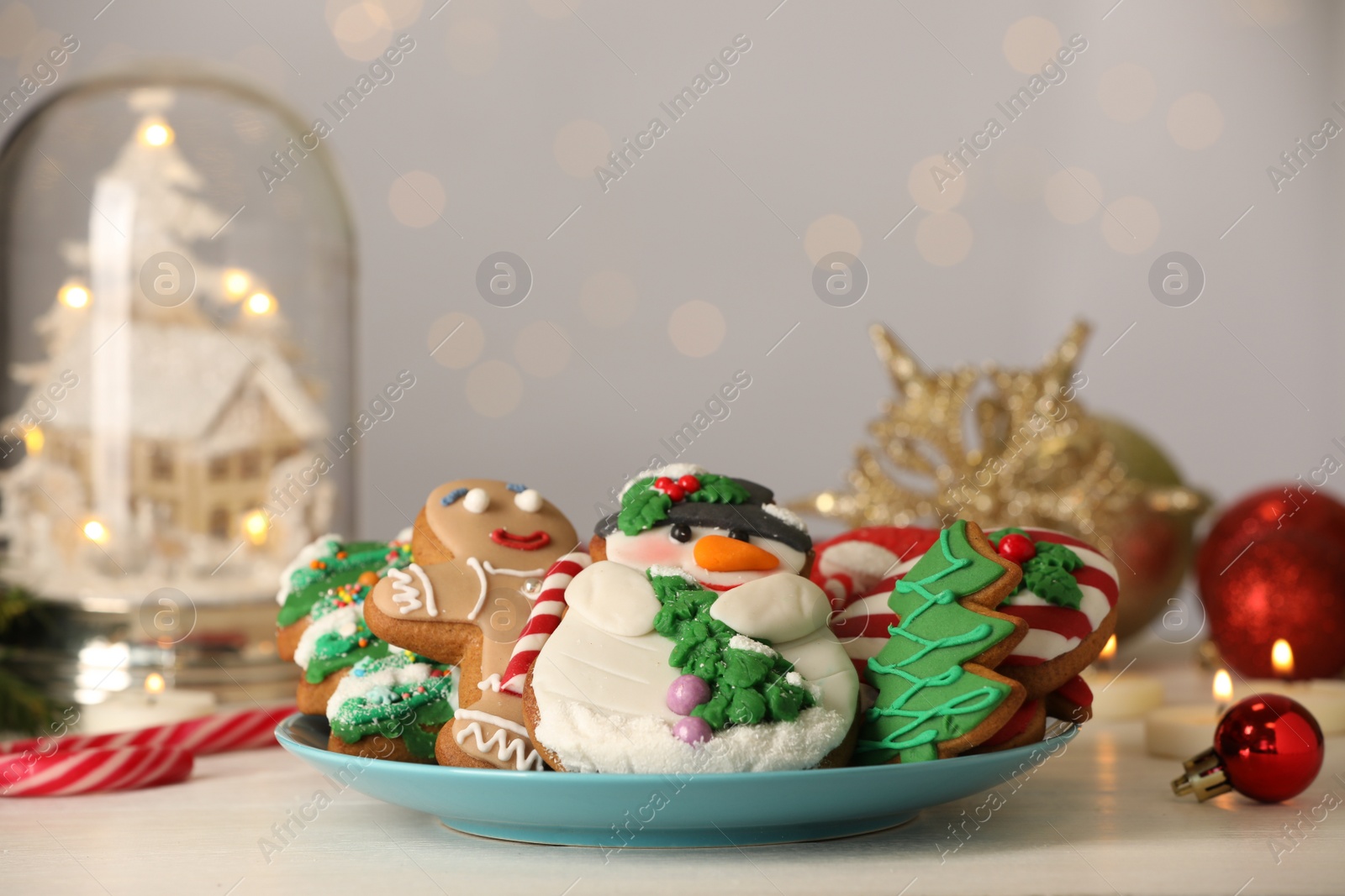 Photo of Sweet Christmas cookies and festive decor on white table