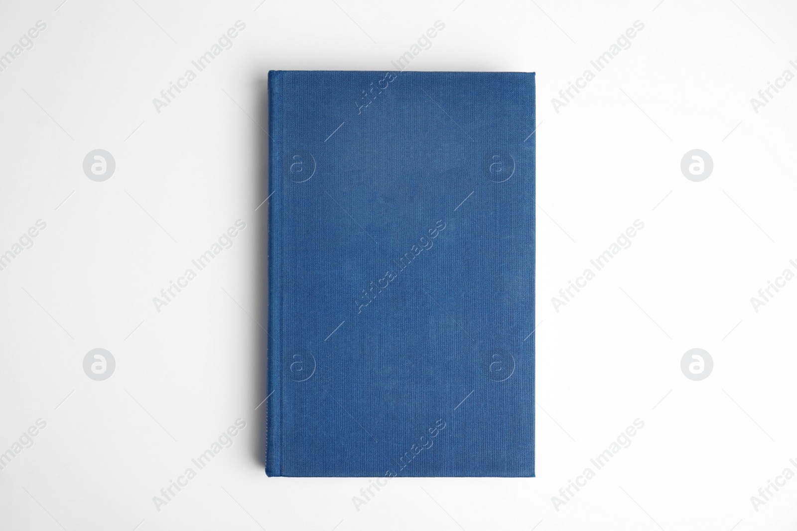 Photo of Hardcover book on white background, top view. Space for design