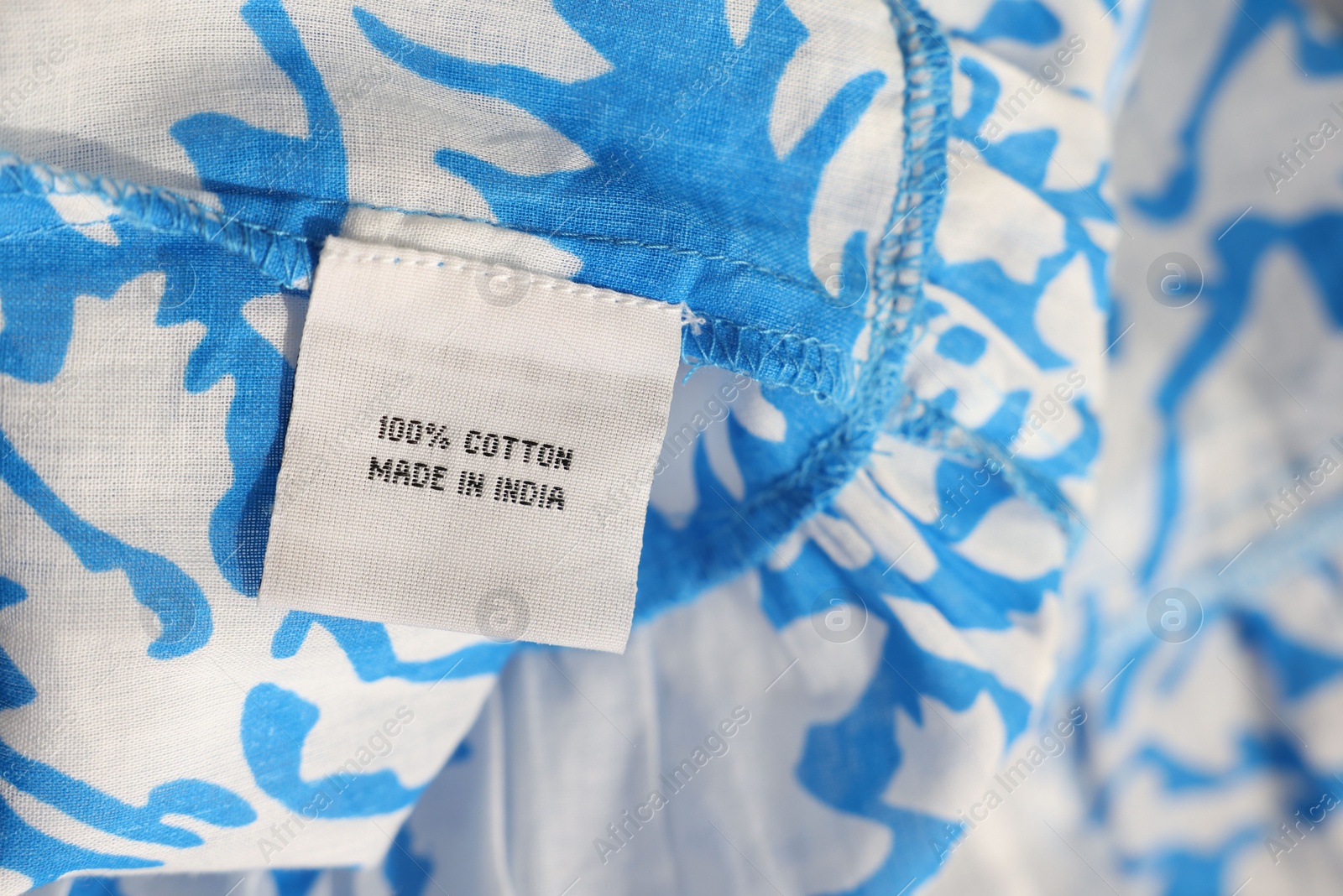 Photo of Clothing label on color garment, closeup view