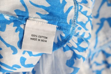 Clothing label on color garment, closeup view