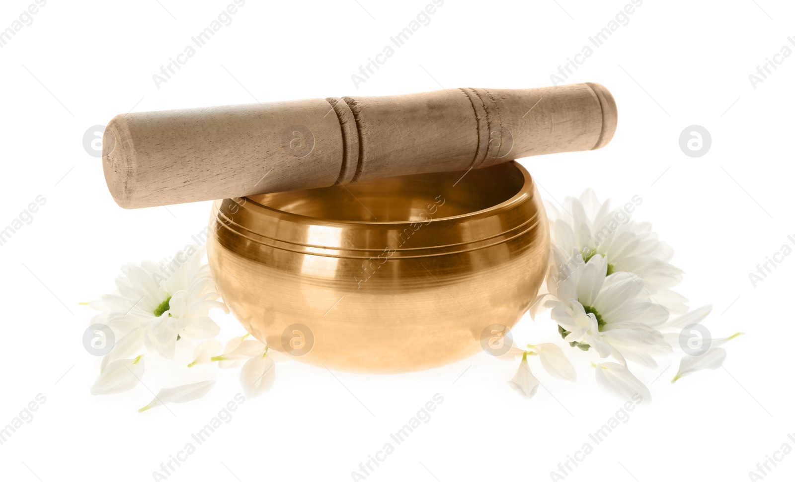 Photo of Golden singing bowl with mallet and flowers on white background. Sound healing