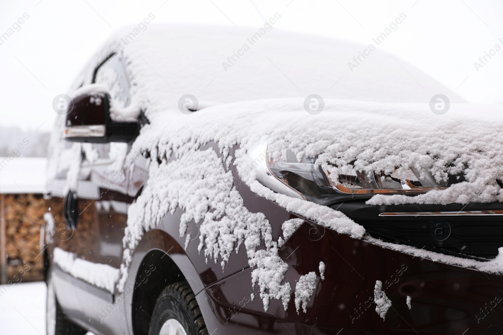 Photo of Car covered with snow after storm outdoors on beautiful winter day, closeup