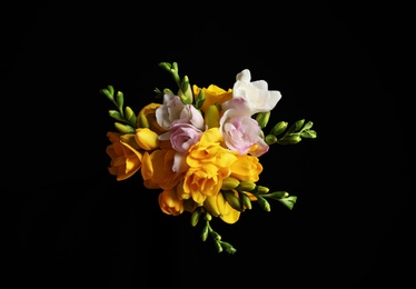 Bouquet of beautiful freesia flowers on black background, top view