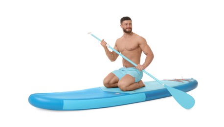 Photo of Handsome man with paddle on blue SUP board against white background