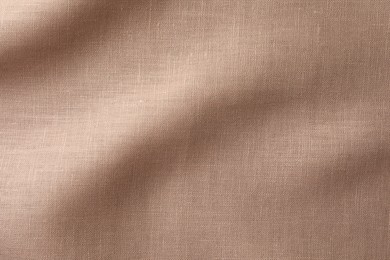 Photo of Texture of brown crumpled fabric as background, top view