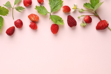 Photo of Many fresh wild strawberries and leaves on beige background, flat lay. Space for text