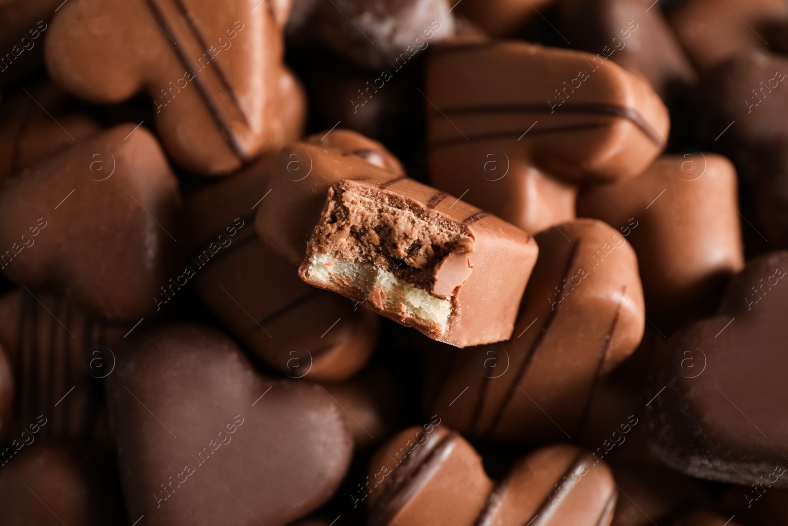 Photo of Beautiful heart shaped chocolate candies as background, top view