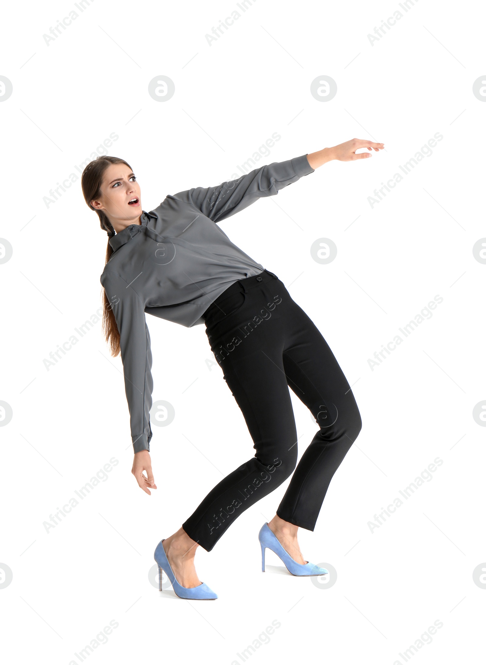 Photo of Young woman attracted to magnet on white background