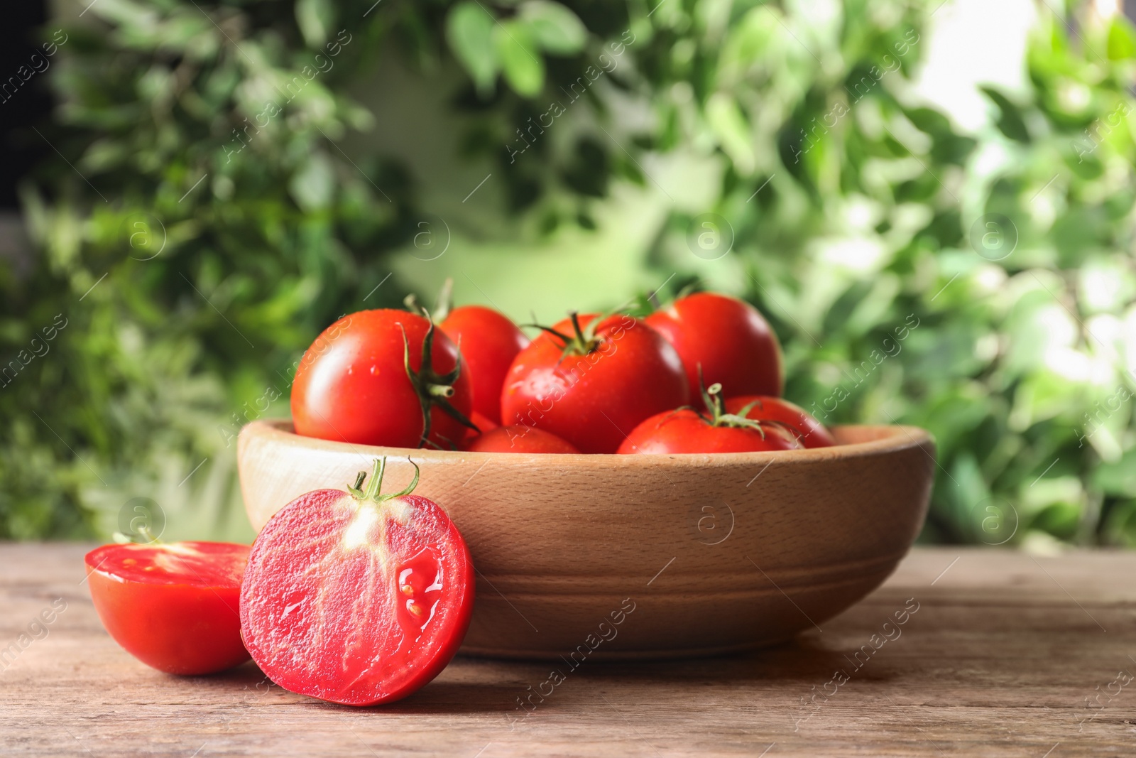 Photo of Fresh ripe red tomatoes on wooden table