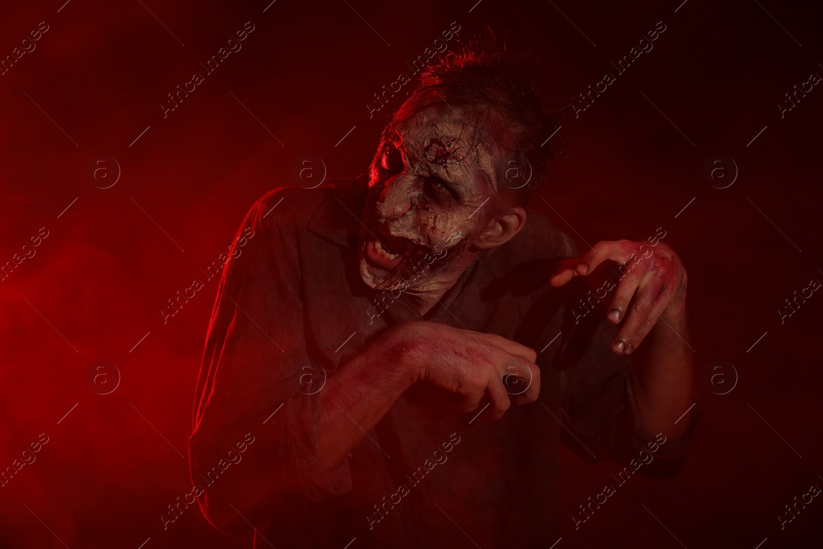 Photo of Scary zombie on dark background. Halloween monster