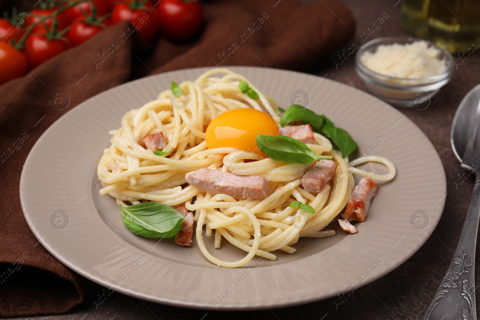 Photo of Delicious pasta Carbonara with egg yolk on table, closeup