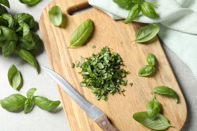 Fresh green basil on light grey table, flat lay