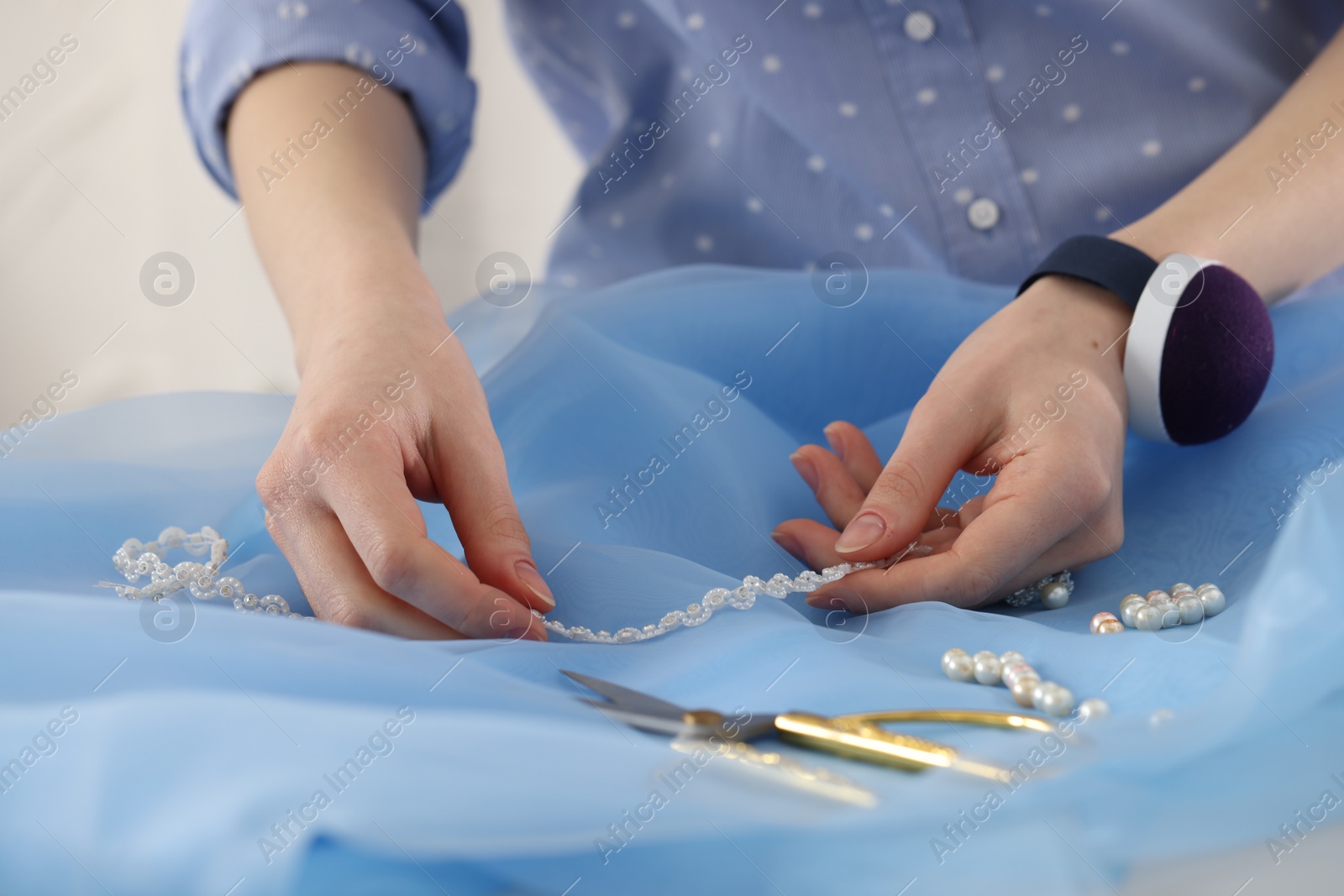 Photo of Dressmaker creating new dress in atelier, closeup