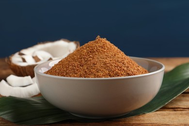 Natural coconut sugar in bowl on wooden table