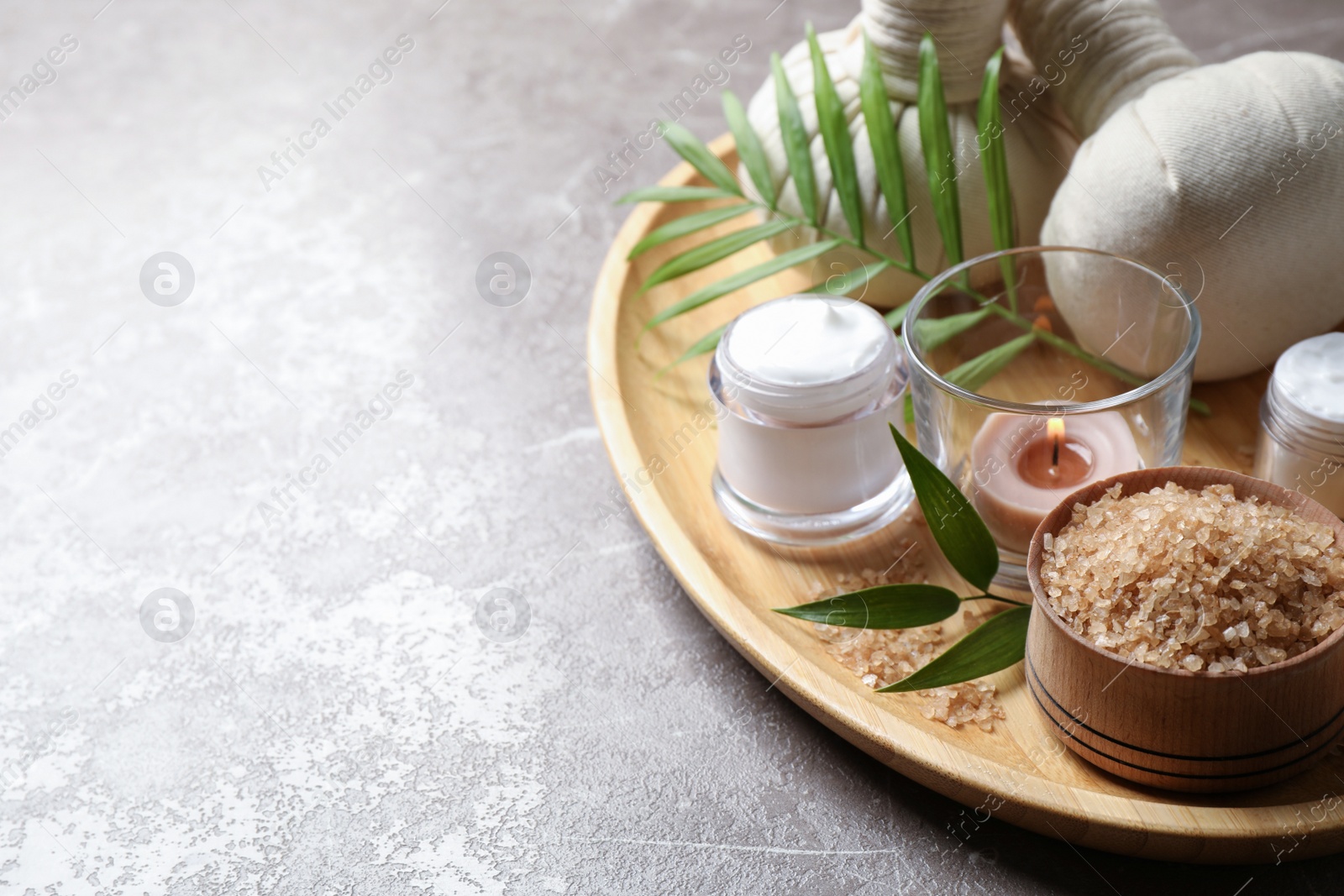 Photo of Spa composition with sea salt on grey table, space for text