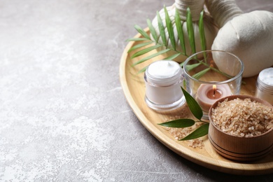 Spa composition with sea salt on grey table, space for text