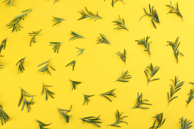 Photo of Frame made of fresh rosemary on yellow background, flat lay