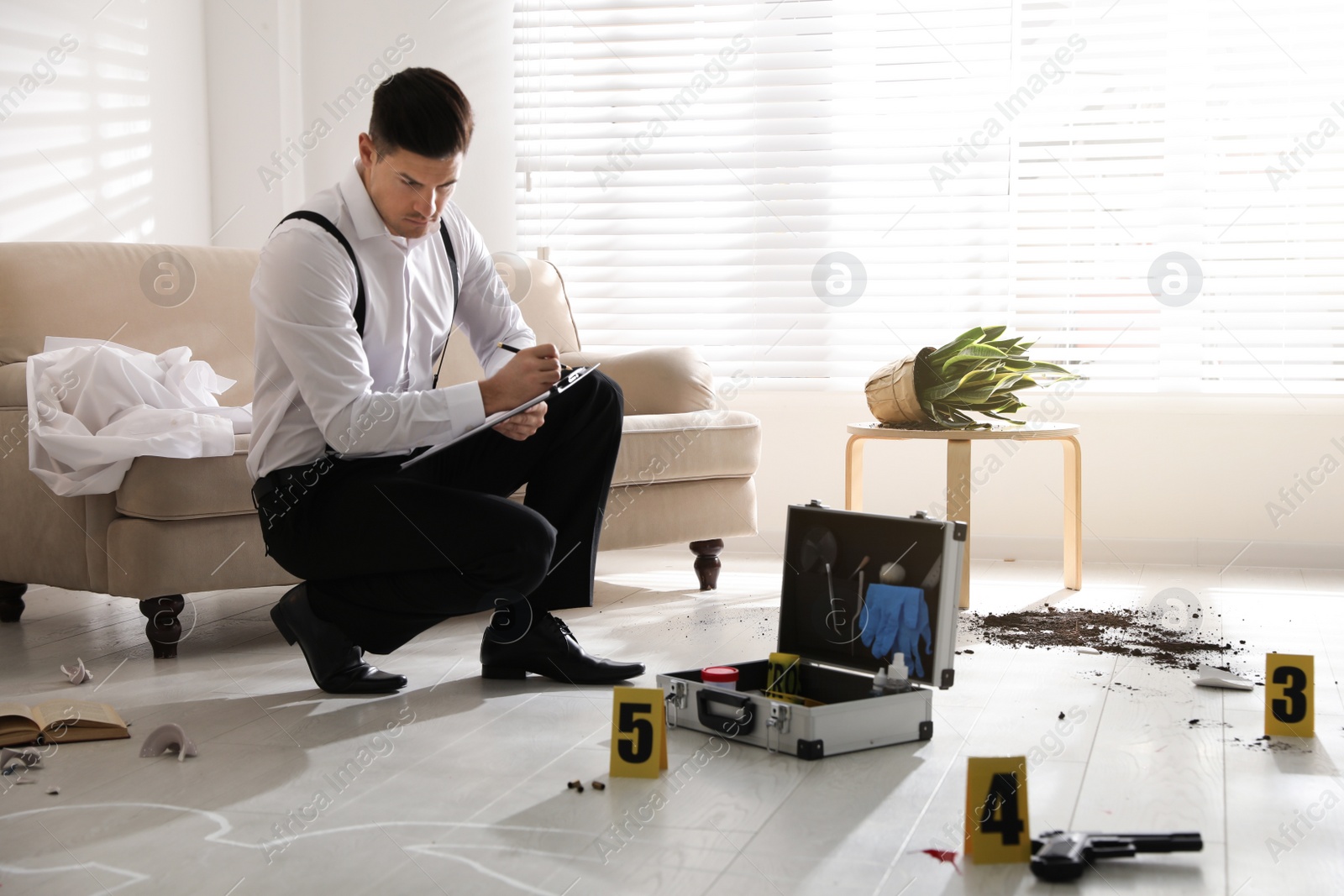 Photo of Investigator working at crime scene in living room