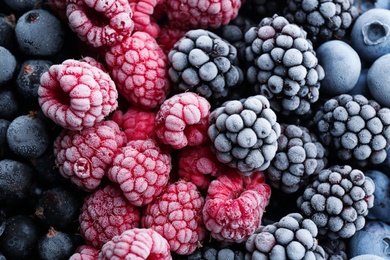 Mix of different frozen berries as background, top view