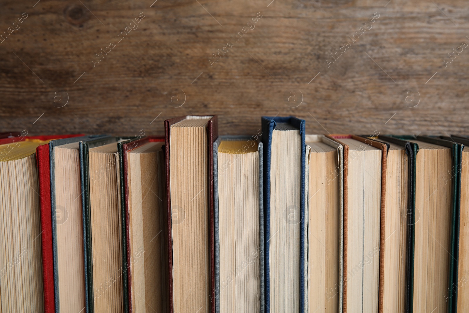 Photo of Stack of hardcover books on wooden background