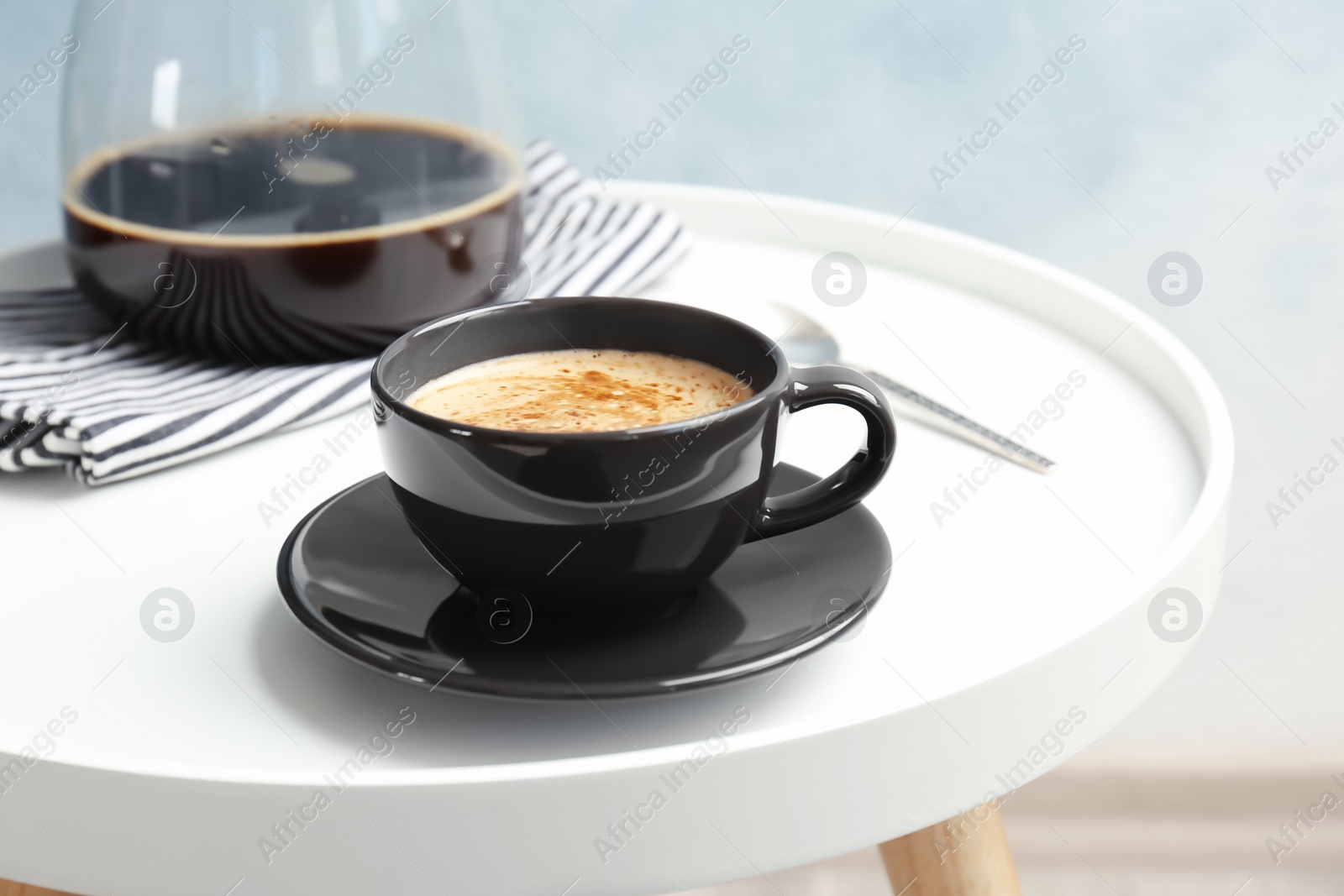 Photo of Cup of aromatic hot coffee on table