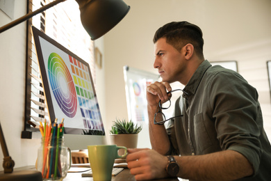 Professional designer working with computer in office