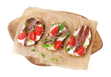 Photo of Delicious bruschettas with anchovies, tomatoes, microgreens and cream cheese on white background, top view